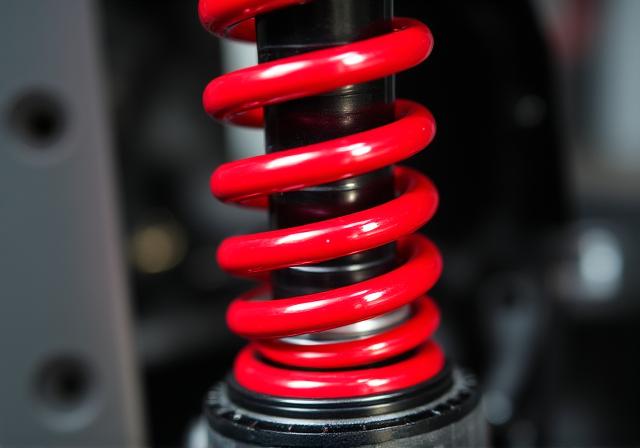 Close up of red lowering springs installed on a vehicle